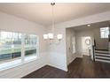 Open-concept dining room featuring hardwood floors and natural light at 4853 Walkers Green, Mableton, GA 30126