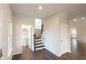 Inviting foyer with hardwood floors, half bath, staircase, and neutral paint scheme at 4853 Walkers Green, Mableton, GA 30126