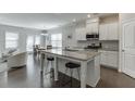Open concept kitchen with white cabinets, stainless steel appliances, and a large island at 1327 Lanier Vista Dr, Buford, GA 30518