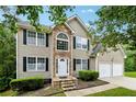 Beautiful two-story home featuring a stone facade and attached two-car garage at 4240 N Braves Cir, Douglasville, GA 30135