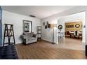 Cozy living room featuring hardwood floors, a comfortable chair, and an open layout at 4240 N Braves Cir, Douglasville, GA 30135