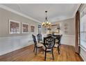 Dining room features hardwood floors, decorative molding, and an elegant chandelier at 5810 Ripplestone Nw Ct, Acworth, GA 30101