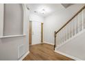 Inviting foyer boasts hardwood floors, a staircase with wooden banister, and natural light at 6000 Suttles Drive Sw, Atlanta, GA 30331