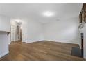 Open-concept living room features hardwood floors, a fireplace, and ample natural light at 6000 Suttles Drive Sw, Atlanta, GA 30331