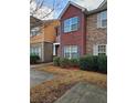 Charming two-story townhome featuring brick and stone facade, complemented by mature landscaping at 2612 Halligan Pointe, Riverdale, GA 30296