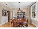Formal dining room with beautiful wallpaper, wood floors, and a striking chandelier at 30 Collier Nw Rd # 6, Atlanta, GA 30309