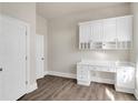 A home office with built-in desk, cabinets, and shelving provides ample storage and workspace at 360 Wembley Cir, Atlanta, GA 30328