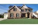Lovely two-story brick home with well-maintained lawn and attached three car garage at 2903 Eva Clb, Acworth, GA 30101