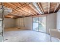 Unfinished basement with a sliding glass door offers great potential for customization at 3344 Creekwood Dr, Rex, GA 30273