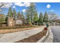 Community entrance with brick sign reading 'Cobblestone At Brookhaven' and manicured landscaping at 1992 Cobblestone Ne Cir, Brookhaven, GA 30319