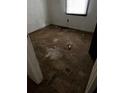 Image of a small bedroom with peeling floors and a window at 2802 Ocean Valley Dr, Atlanta, GA 30349