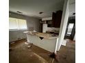 View of an outdated kitchen featuring a center island, window, and cabinets at 2802 Ocean Valley Dr, Atlanta, GA 30349