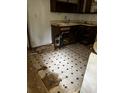 Picture of a damaged kitchen featuring patterned floors and outdated cabinets at 2802 Ocean Valley Dr, Atlanta, GA 30349