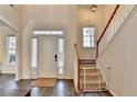 Inviting foyer with hardwood floors, staircase, and natural light streaming through the front door windows at 3202 Monarch Pine Dr, Peachtree Corners, GA 30071