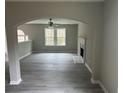 Spacious living room with gray wood floors, a fireplace, and a ceiling fan for comfort at 7054 Shenandoah Trl, Austell, GA 30168