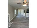 Open-concept living room with gray floors, fireplace, and archways to other rooms at 7054 Shenandoah Trl, Austell, GA 30168