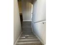 A staircase with modern gray wood floors and white banister leads to the upper level of the home at 7054 Shenandoah Trl, Austell, GA 30168