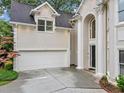 Detailed view of the home's architectural features, including the garage and columned entryway at 910 Renaissance Way, Roswell, GA 30076