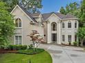 Charming exterior showcasing lush landscaping and a well-maintained driveway at 910 Renaissance Way, Roswell, GA 30076