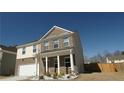 Beautiful two-story home with white columns on the porch and a well-maintained front lawn at 1603 Maston Rd, Auburn, GA 30011