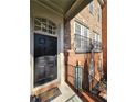 Inviting front door with sidelight windows and charming architectural details with brick stairs and wrought iron at 2823 Mount Wilkinson Se Pkwy # 14, Atlanta, GA 30339