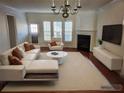 Bright, staged living room with fireplace, modern furniture, and hardwood floors at 2823 Mount Wilkinson Se Pkwy # 14, Atlanta, GA 30339
