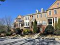 Brick townhomes offer elegance and style, complemented by manicured landscaping and inviting curb appeal at 2823 Mount Wilkinson Se Pkwy # 14, Atlanta, GA 30339