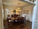 Traditional dining room with a polished wood table, chandelier, and decorative accents at 4045 Boles Creek Dr, Duluth, GA 30096