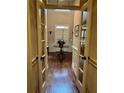Elegant foyer features hardwood floors and a decorative table with fresh flowers at 4045 Boles Creek Dr, Duluth, GA 30096