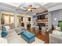Open-concept living room with hardwood floors, coffered ceilings, and a cozy fireplace at 5008 Whiteoak Pointe Se # 15, Smyrna, GA 30080
