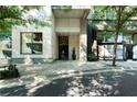 Modern building entrance with glass doors, landscaping and clear signage at 1100 Howell Mill Nw Rd # 708, Atlanta, GA 30318