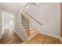 Staircase with wooden steps, black iron railings, and natural light for a welcoming ambiance at 130 Staddlebridge Ave, Canton, GA 30114