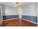 Formal dining room featuring hardwood floors, classic chandelier, and two-tone walls at 4030 Brushy Creek Way, Suwanee, GA 30024