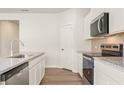 Kitchen with stainless steel appliances, white cabinets, and granite countertops at 4167 Viola Pl, Atlanta, GA 30349