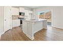 Bright kitchen features white cabinets, granite counters, stainless appliances and island with sink at 4167 Viola Pl, Atlanta, GA 30349