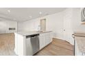 Bright kitchen with stainless steel dishwasher and granite countertop island overlooking open living area at 4167 Viola Pl, Atlanta, GA 30349