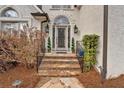 Inviting front entry featuring stone steps, elegant iron railings, manicured shrubs, and decorative topiaries at 5382 Whitaker Nw Trl, Acworth, GA 30101