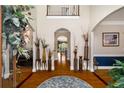 Elegant foyer with hardwood floors, arched doorways, and decorative vases lining the hallway at 2212 Austin Lake Se Dr, Smyrna, GA 30082