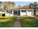 Inviting single-story home with a blue front door and a well-manicured green lawn at 2886 Salmon Se Ave, Atlanta, GA 30317