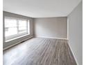 Bright living room with neutral paint, large window and modern gray flooring at 3230 Jamaica Nw Rd, Atlanta, GA 30318