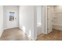 Bright entryway featuring hardwood floors, a white front door with glass inserts, and an adjacent doorway at 4163 Viola Pl, Atlanta, GA 30349