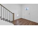 Home entryway with durable flooring and a craftsman style front door and metal stair railing at 482 Hammons Way, Atlanta, GA 30315