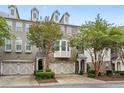 A row of brick townhouses with lush landscaping and driveways leading to attached one car garages at 6080 Indian Wood Se Cir, Mableton, GA 30126