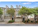 A row of townhouses with brick facades, lush landscaping, and attached one car garages at 6080 Indian Wood Se Cir, Mableton, GA 30126