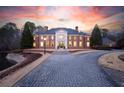 Stately brick home featuring manicured landscaping, grand entrance, and circular drive with ample parking at 4615 Northside Dr, Atlanta, GA 30327