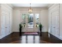 Bright foyer featuring beautiful hardwood floors, stylish paneled walls, and an elegant front entrance at 4615 Northside Dr, Atlanta, GA 30327