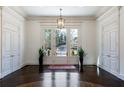 Bright foyer featuring neutral walls, elegant chandelier, and beautiful floors at 4615 Northside Dr, Atlanta, GA 30327