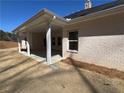 A covered patio area with support pillars, concrete flooring, and view of the yard at 5311 Tuscany Drive, Douglasville, GA 30135