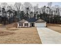 View of the charming one-story home with a well-manicured lawn in a quiet neighborhood at 5311 Tuscany Drive, Douglasville, GA 30135