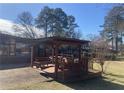 Backyard deck including covered bench seating, making it great for entertaining at 1655 Old Salem Rd, Covington, GA 30013